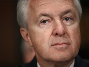 The face of sad, bland, corporate… not really *evil* per se. More like… tepid immorality? Rich white male indifference?
